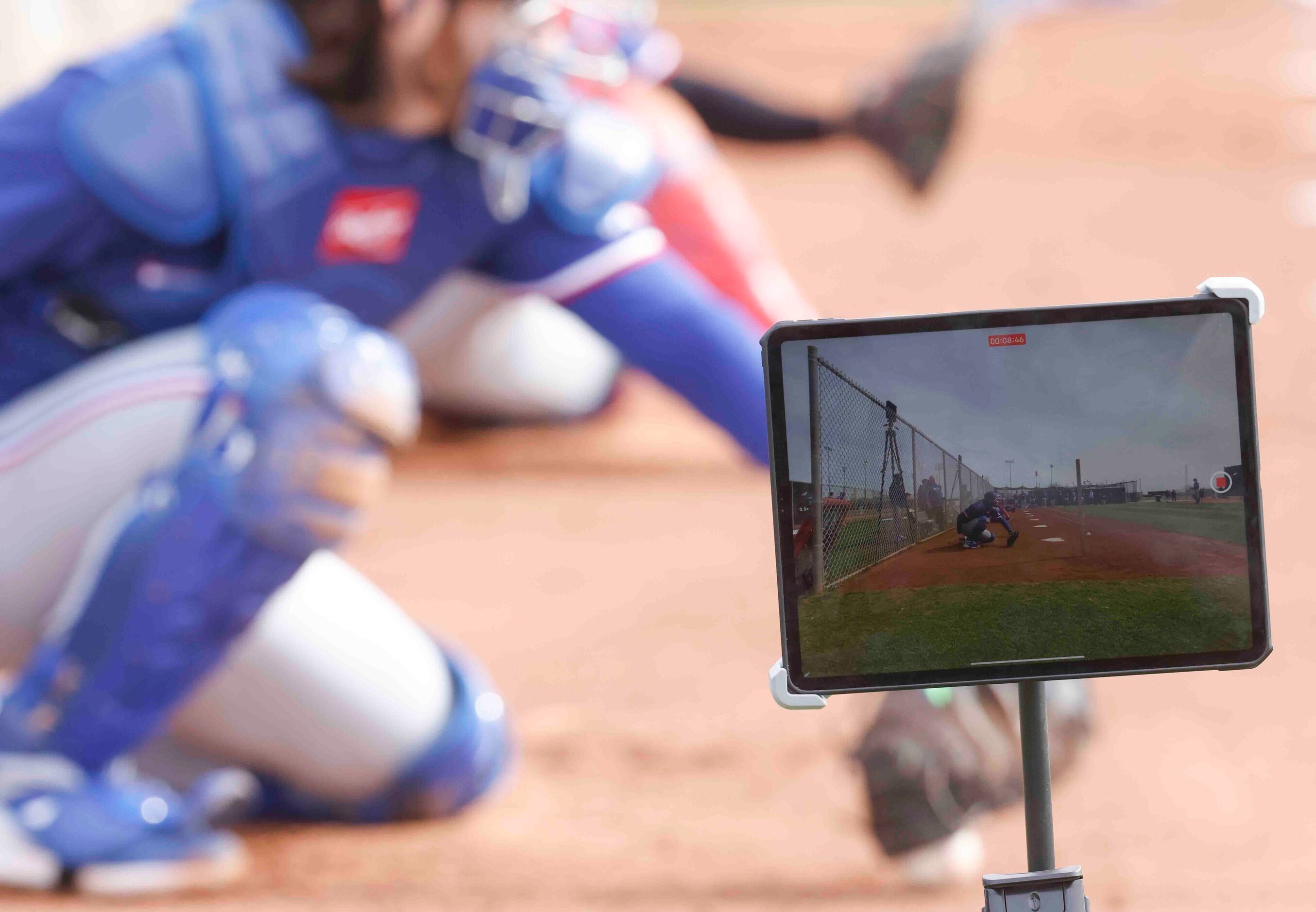 A tablet records the catchers during a spring training workout at the team's training...