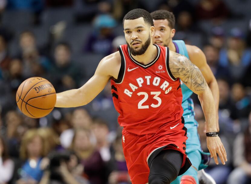 Toronto Raptors' Fred VanVleet, right, brings the ball up the court against the Charlotte...