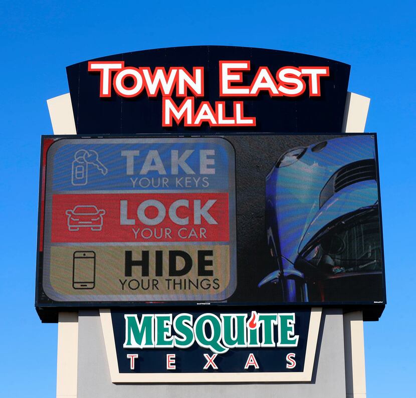 A "Take, Lock, Hide" sign is seen at Town East Mall in Mesquite.