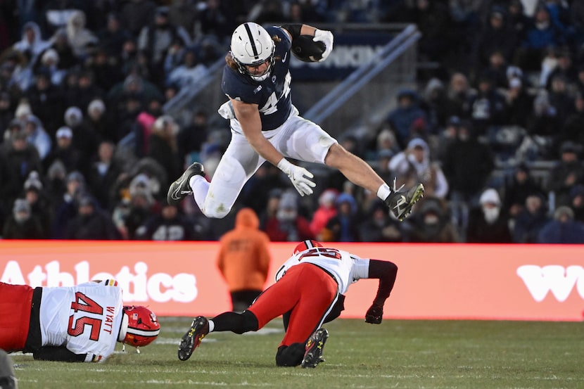 Penn State tight end Tyler Warren (44) hurdles Maryland defensive back Kevis Thomas (25)...