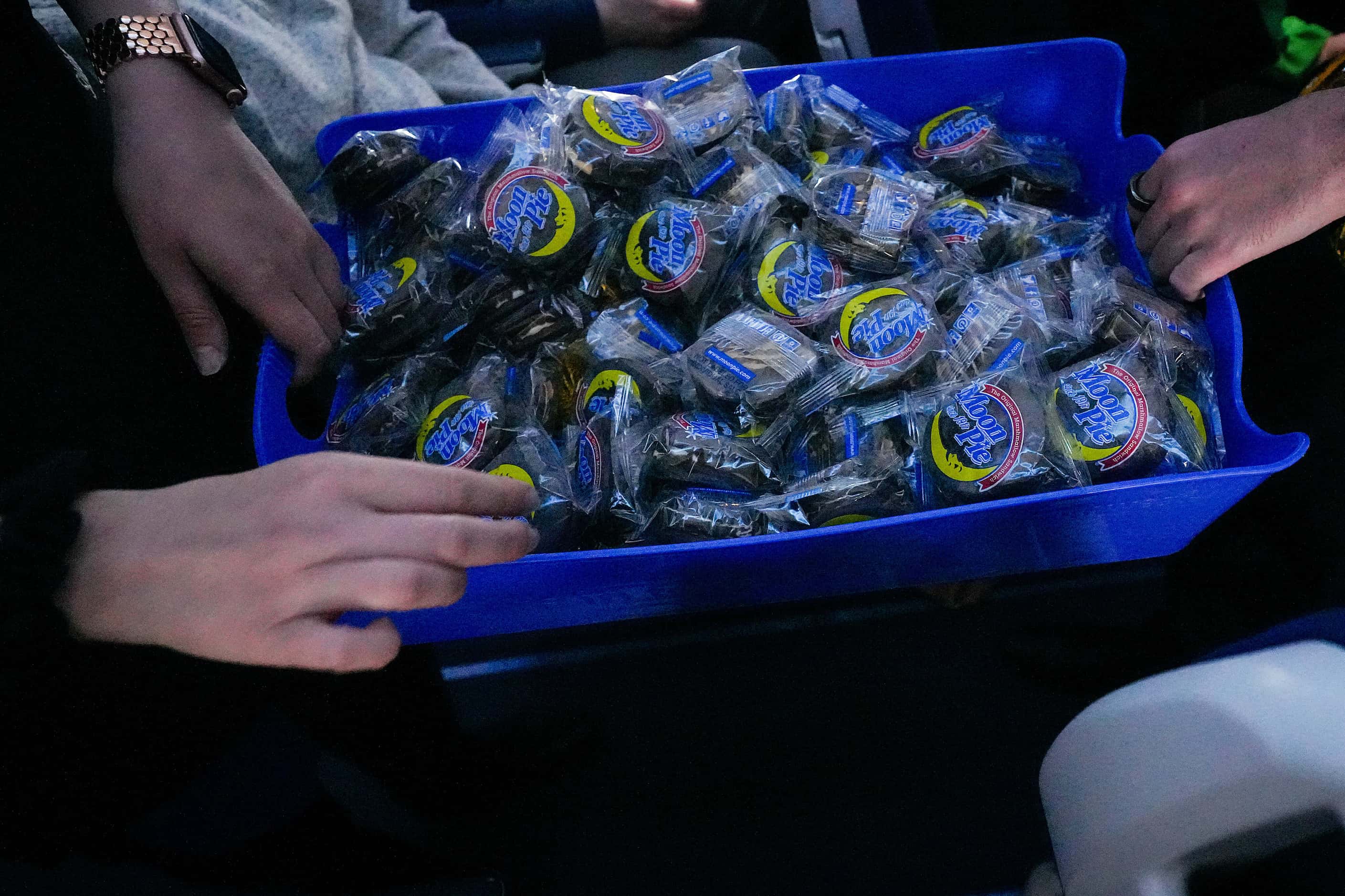 Flight attendants hand out Moon Pies during the early stages of a total solar eclipse on...