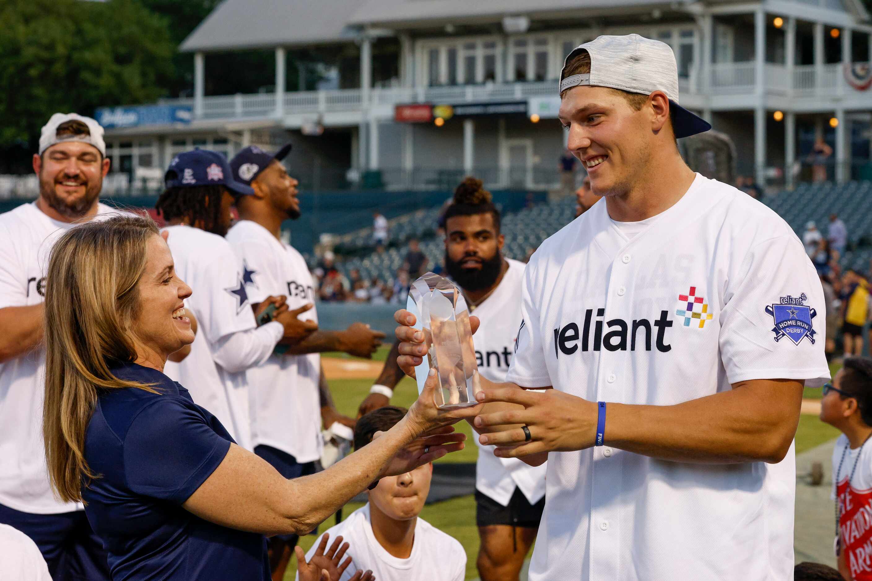 Leanne Schneider, Reliant Energy director of community relations, presents the winner’s...