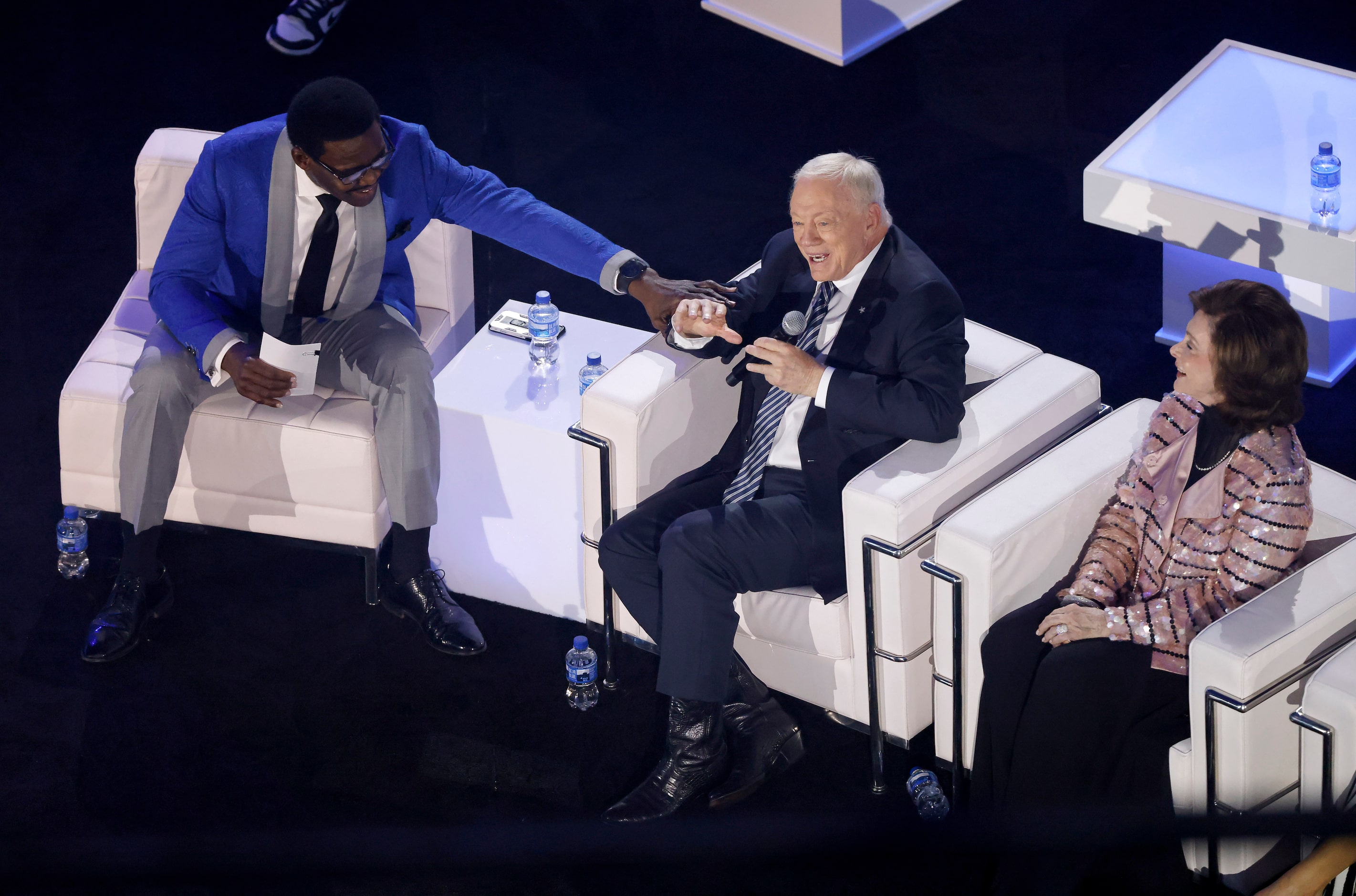 Dallas Cowboys Hall of Fame wide receiver Michael Irvin (left) tries to tap down team owner...