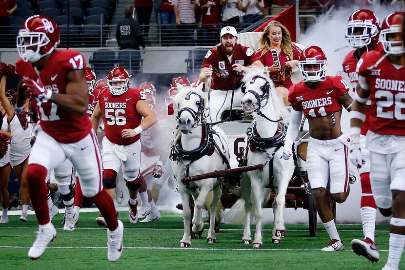 The Sooner Schooner leads the Oklahoma Sooners football team onto the field to face the TCU...