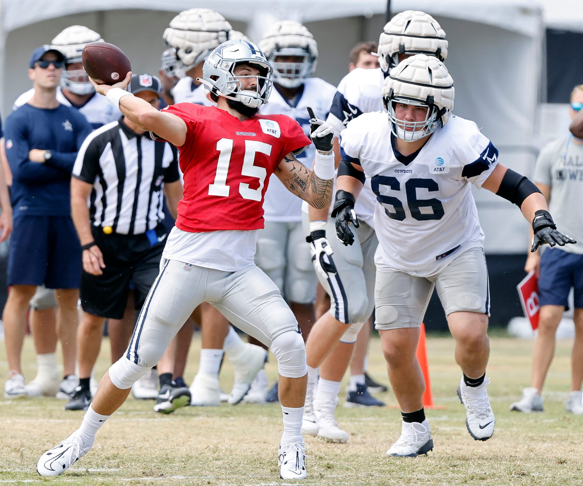 Dallas Cowboys quarterback Will Grier (15) fires pass as guard Connor McGovern (66) closes...