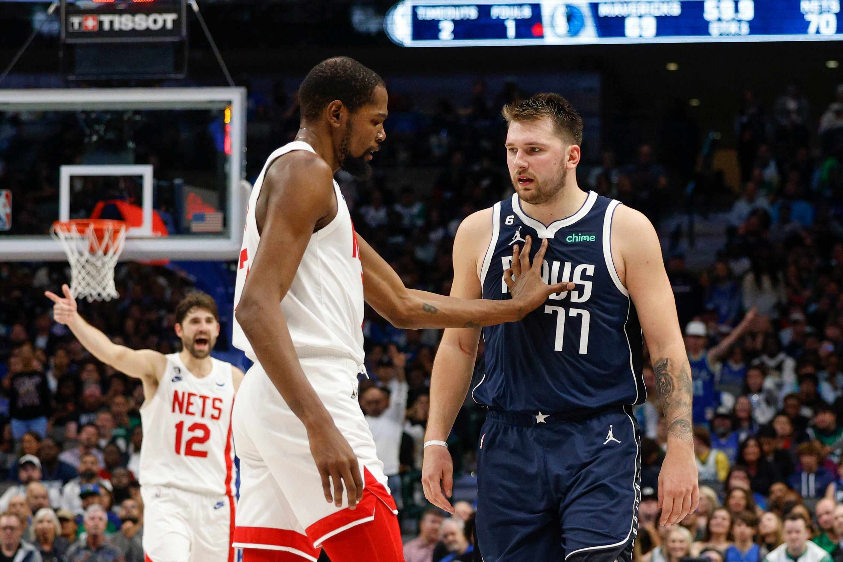 Brooklyn Nets forward Kevin Durant (7) pushes Dallas Mavericks guard Luka Doncic (77) back...