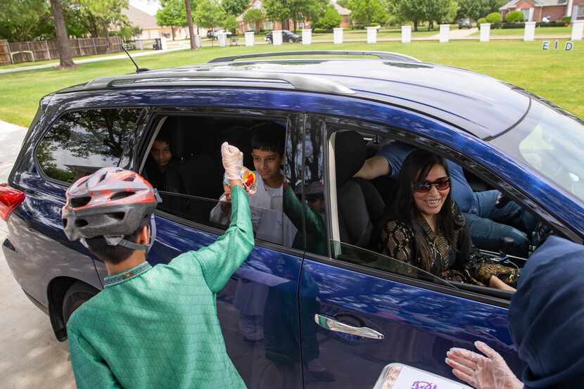 The Usmani family drives by Abdul Hayee and Qudsia Nadeem Eid celebration on Sunday in Plano.