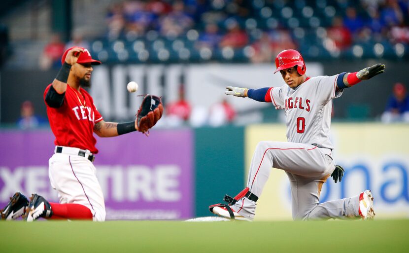 Los Angeles Angels batter Yunel Escobar (0) signals he's safe at second on a first inning...