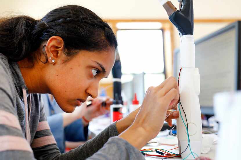 Girl Scout Esha Patel, a sophomore at Harmony Science Academy in Carrollton, assembles...