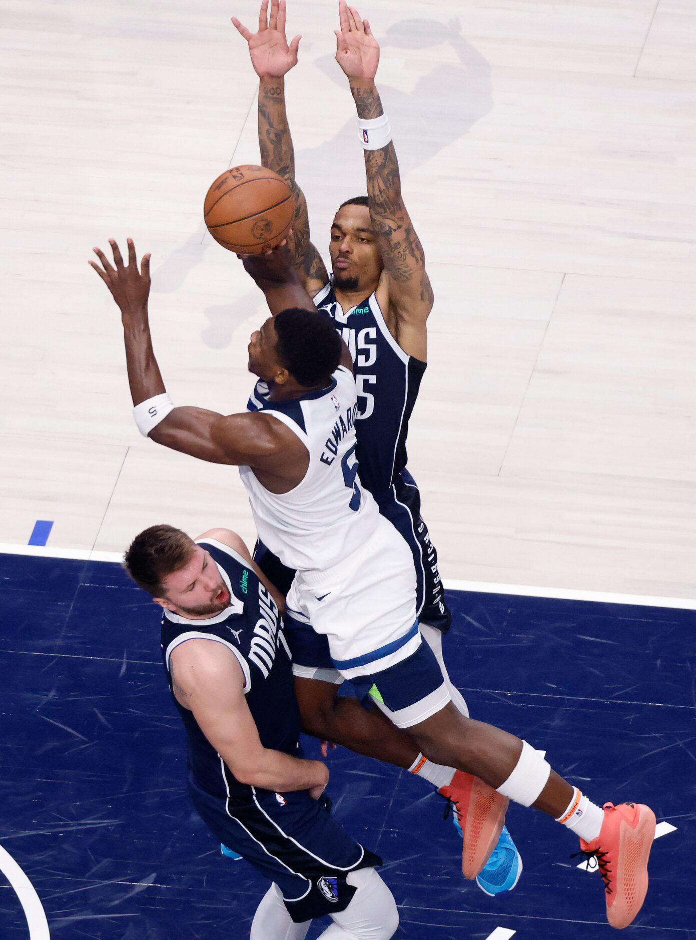 Dallas Mavericks guard Luka Doncic (77) draws a charge from Minnesota Timberwolves forward...