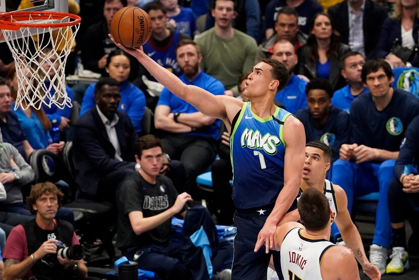 Dallas Mavericks forward Dwight Powell (7) shoots over Denver Nuggets center Nikola Jokic...