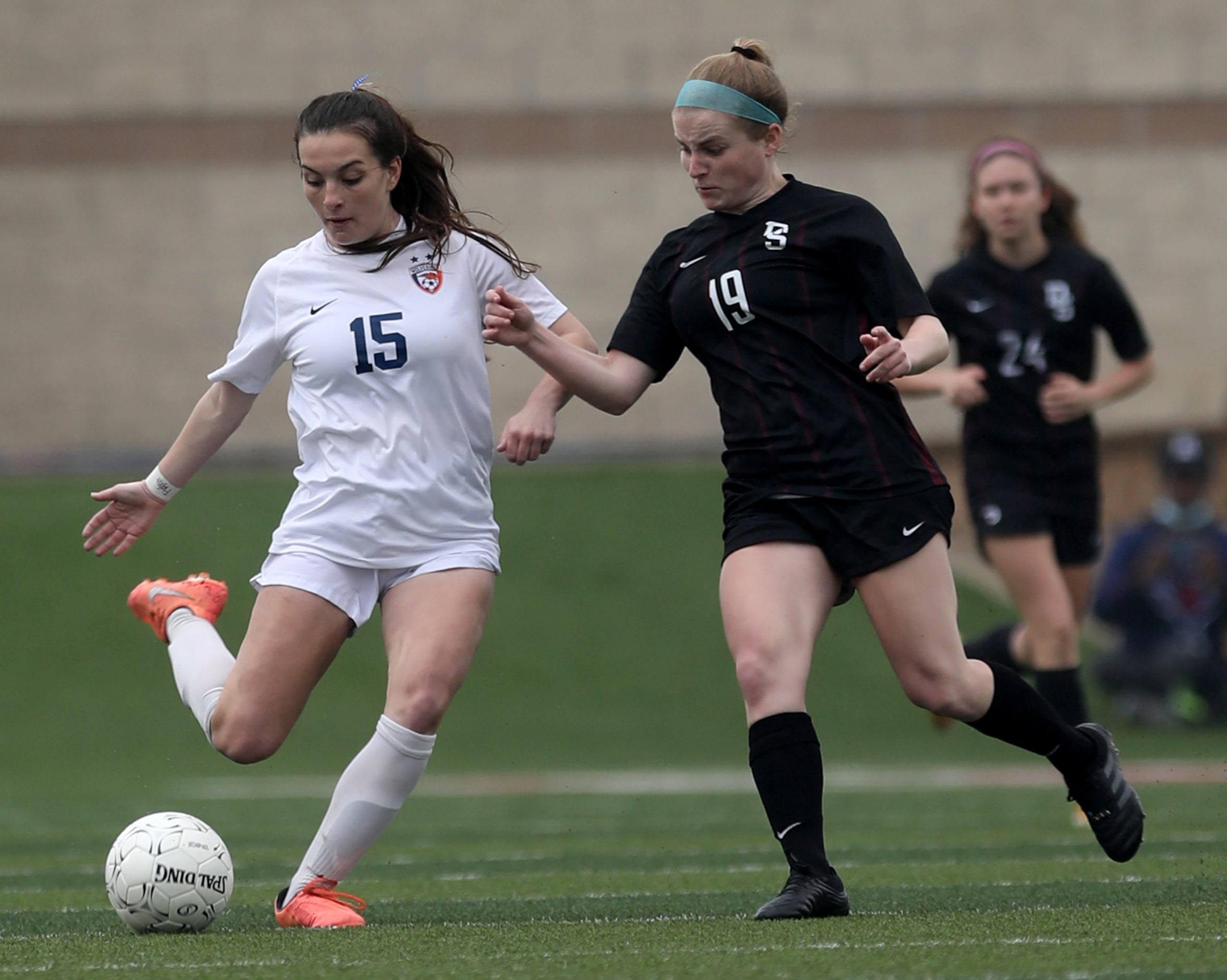 Wakeland's Ally Perry (15) and Dripping Springs'  Avery Davis (19)  chase after the ball...