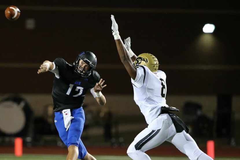 Hebron quarterback Clayton Tune (12) throws the ball while being covered by Plano East...