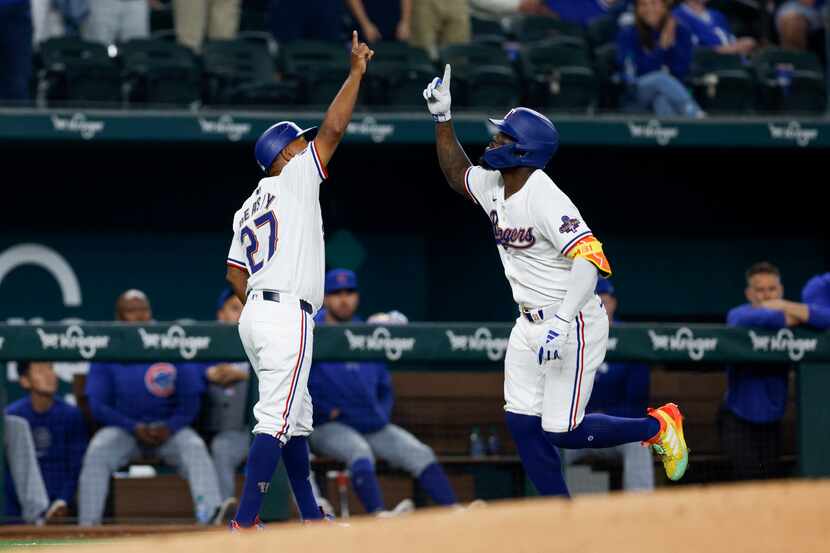 Texas Rangers right fielder Adolis Garcia (53) celebrates his home run with third base coach...