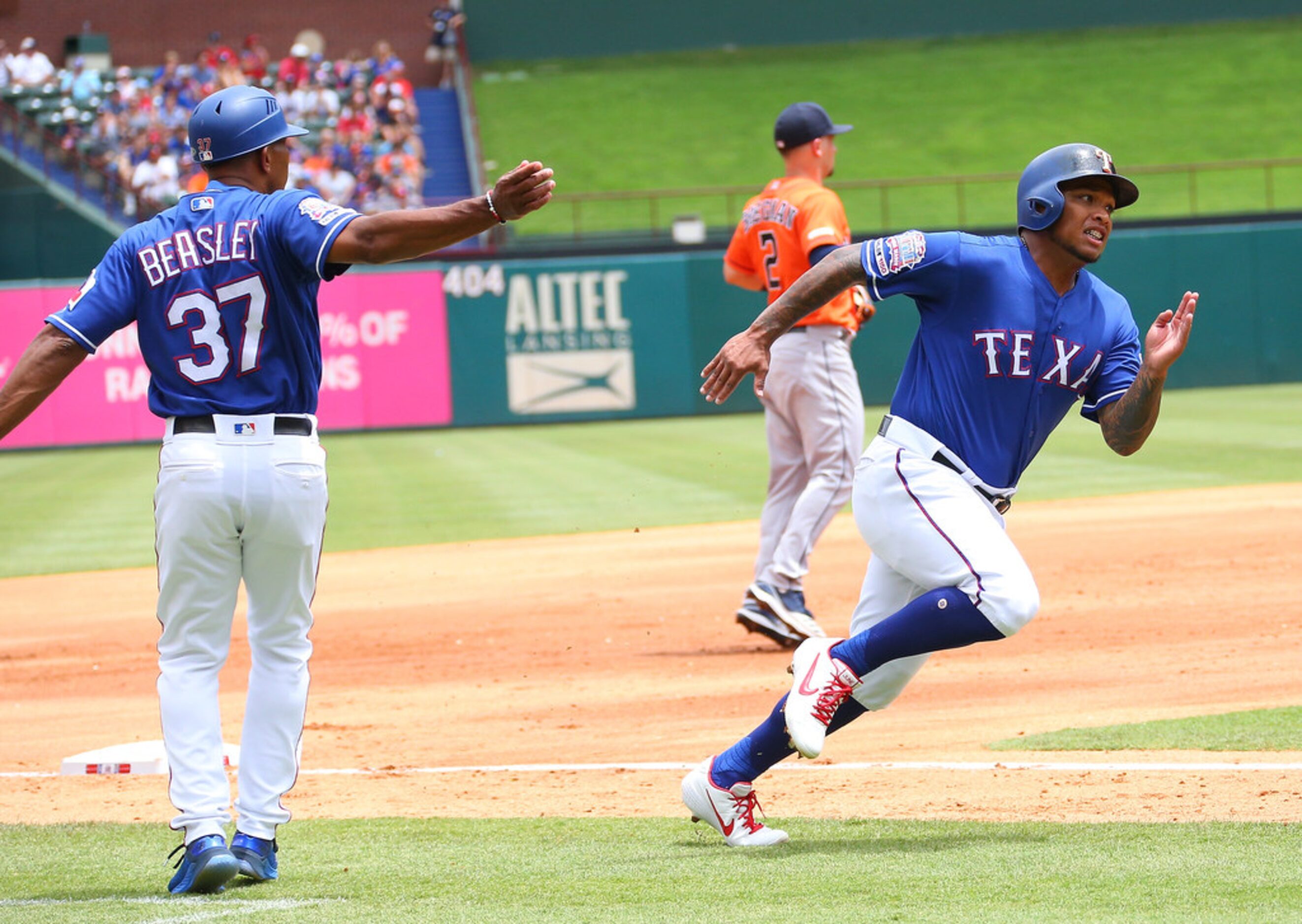 ARLINGTON, TX - JULY 14: Shawn Kelley #27 of the Texas Rangers waves in Willie Calhoun #5 to...