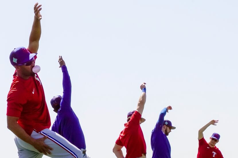 Texas Rangers infielder Marcus Semien as he stretches with teammates during a spring...