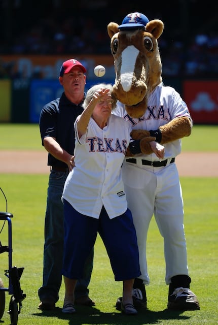  Elizabeth Sullivan, 105, threw out the ceremonial first pitch Wednesday while being held by...