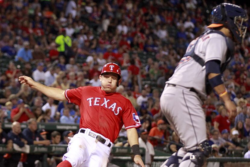 Texas Rangers second baseman Ian Kinsler (5) slides safely into home on an Elvis Andrus hit...