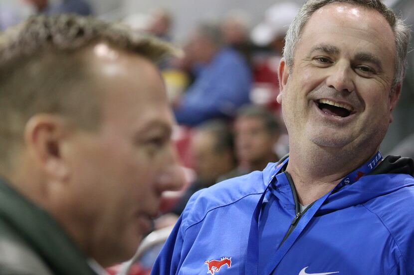 New Southern Methodist Mustangs football head coach Sonny Dykes speaks to patrons before an...