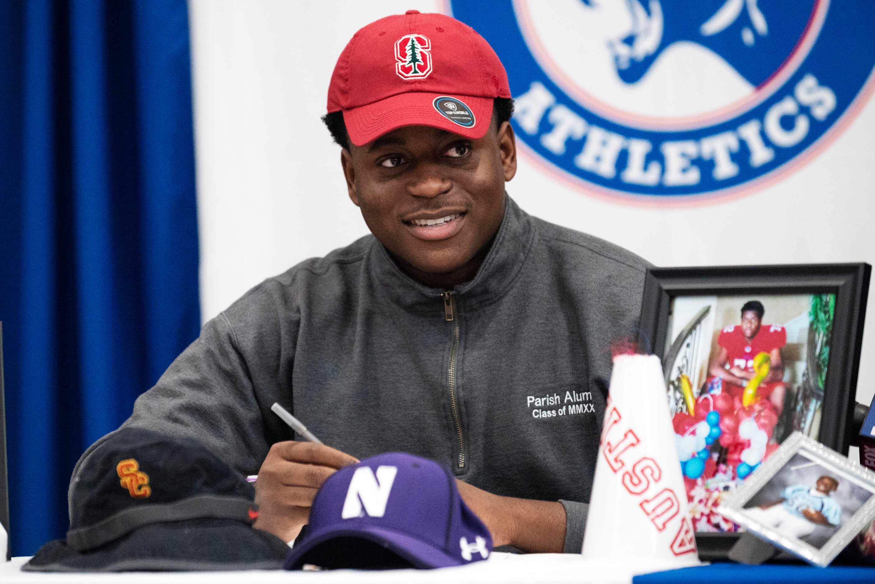 Parish Episcopal senior Austin Uke smiles while sporting a Stanford University cap as he...