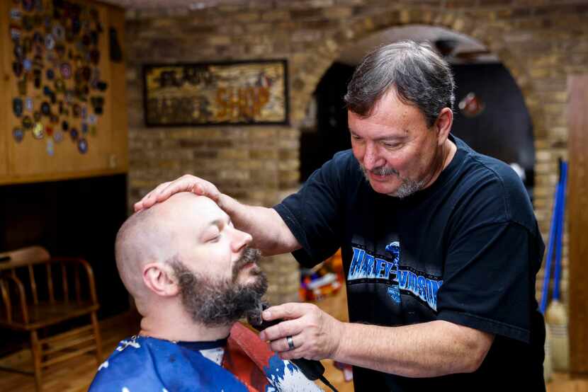 Plano Barbers owner James Russell grooms customer Joe Elkington of Richardson ahead of...
