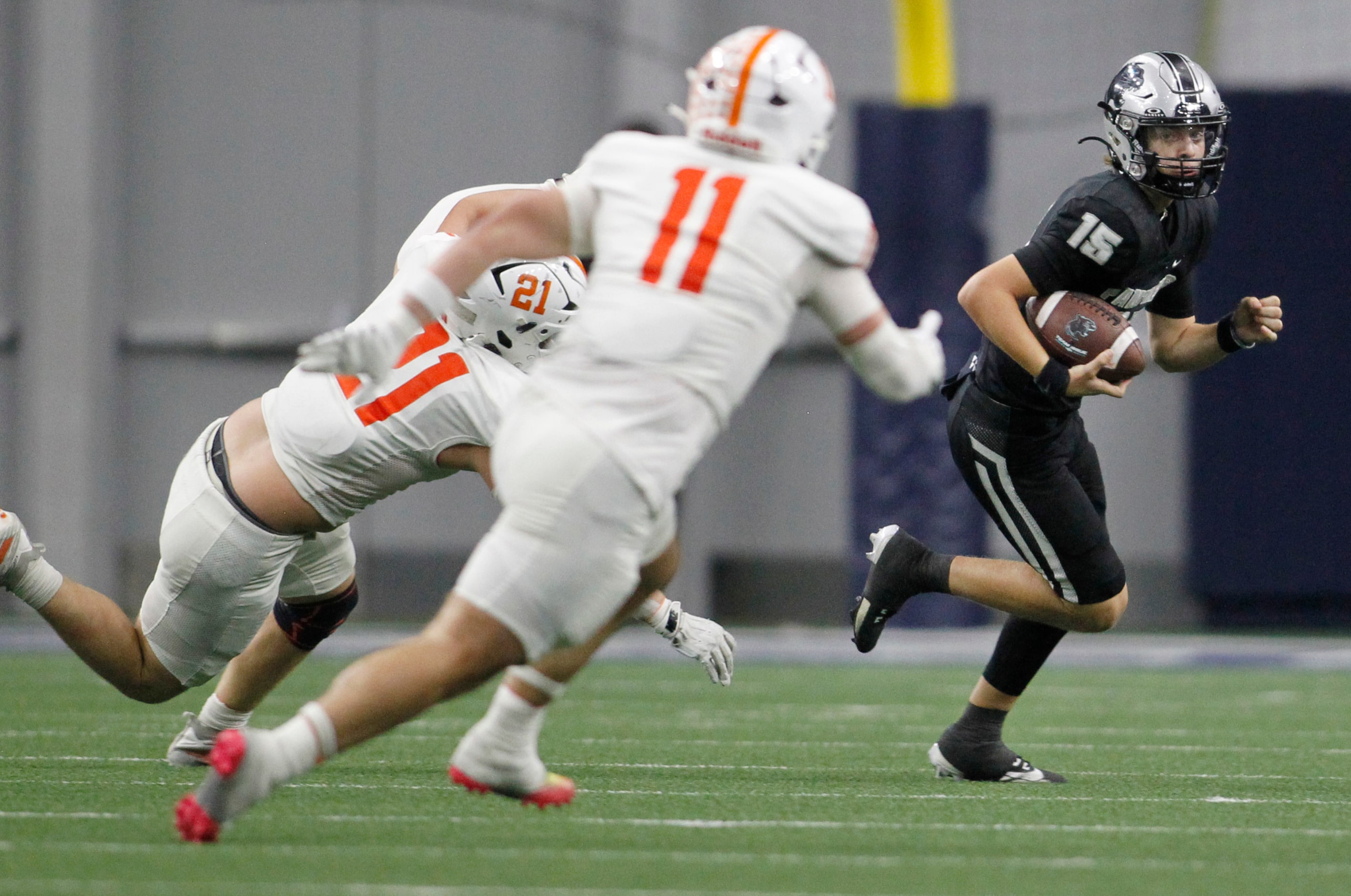 Frisco Panther Creek quarterback Graylyn Fry (15) looks for running room as he rolls out of...