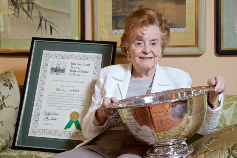 Nancy Jeffett poses with the Maureen Connolly Brinker Tennis Foundation Life-time member cup...