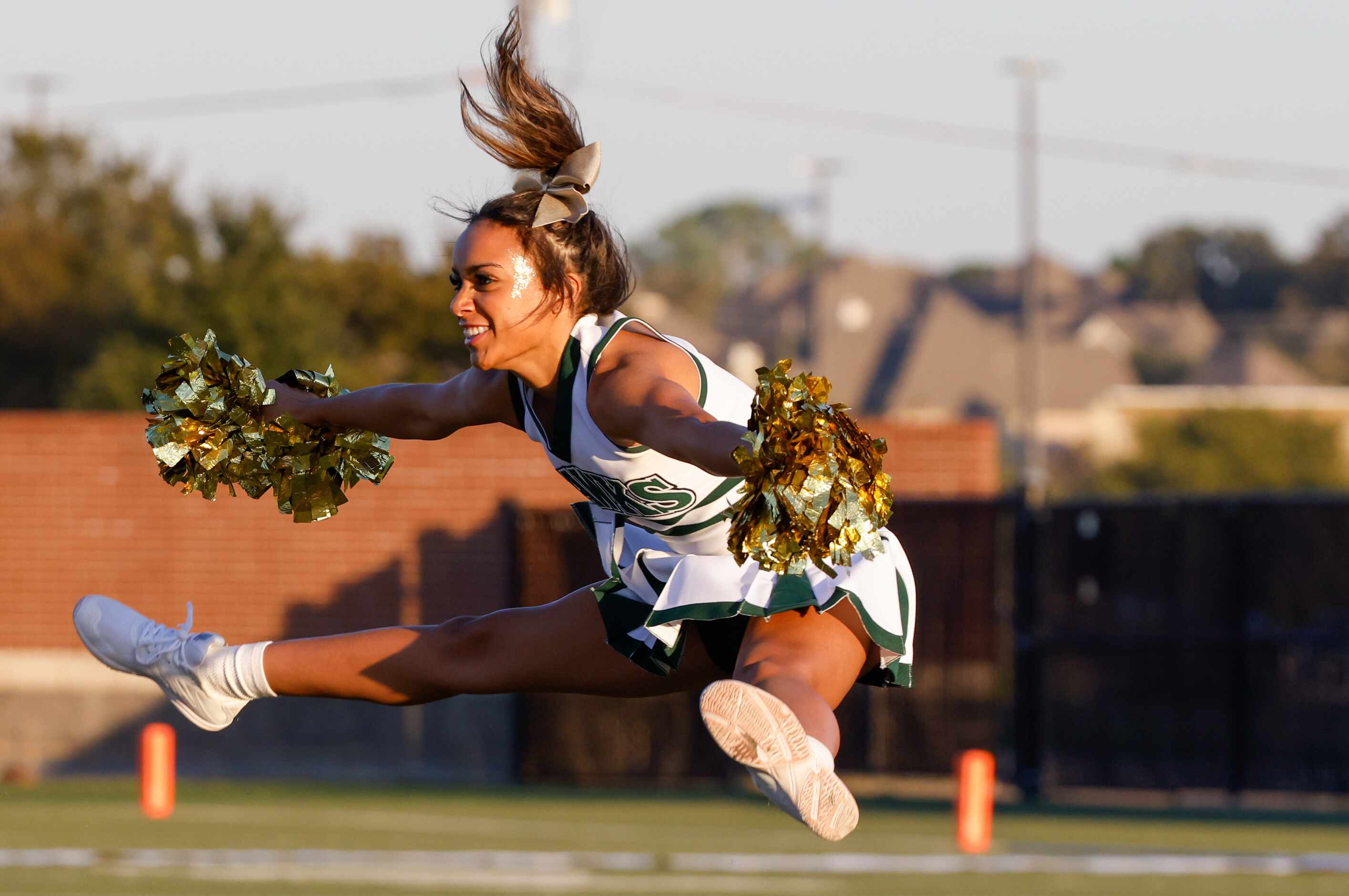 Birdville cheerleaders perform tricks as they are introduced to the crowd before a game...