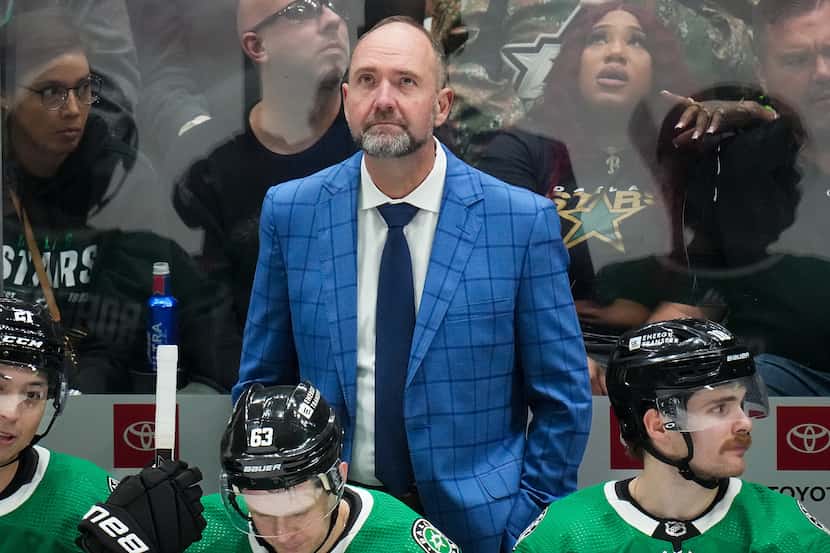 Dallas Stars head coach Pete DeBoer watches from the bench during overtime of an NHL hockey...