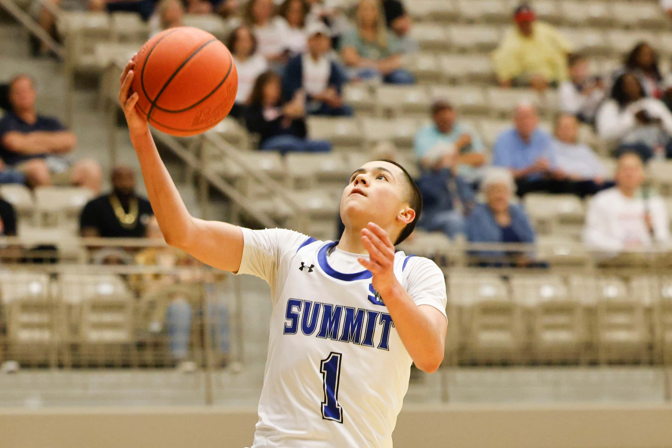 Mansfield Summit’s Theo Brannan drives to the basket against Denton Ryan during the first...