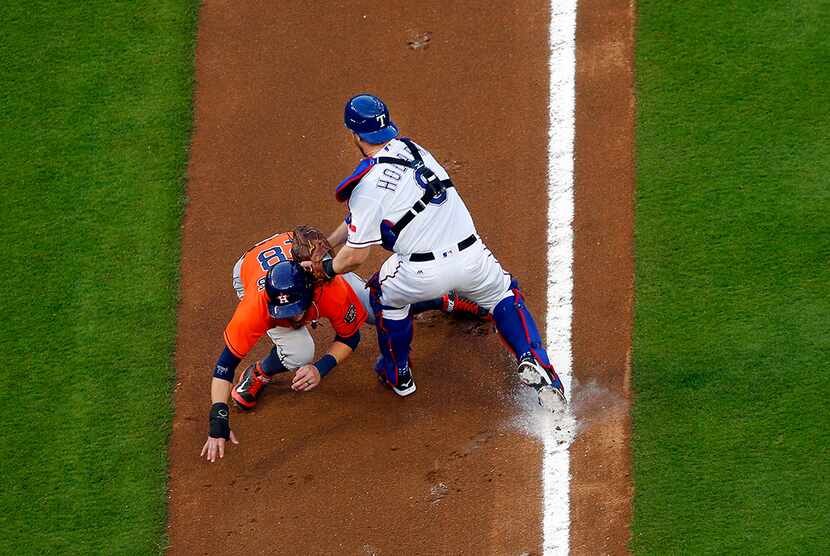  Texas Rangers catcher Bryan Holaday (8) tags out Houston Astros Colby Rasmus (28) on the...