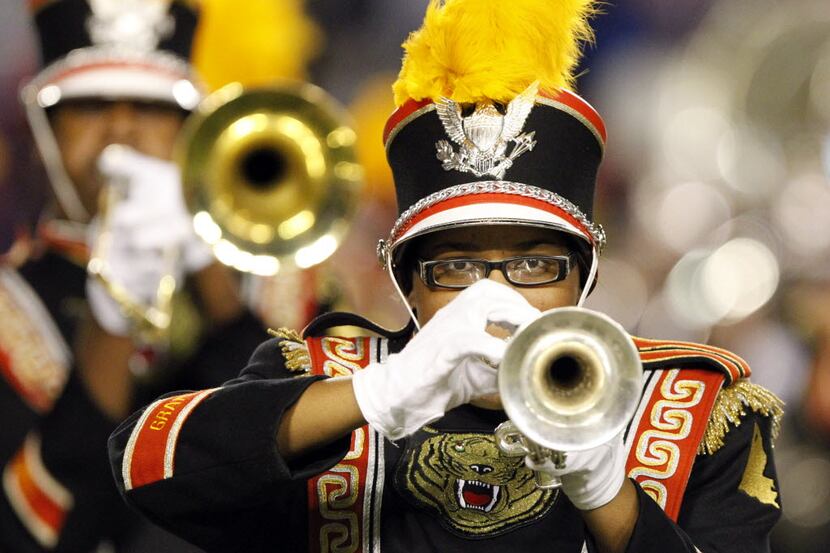 A Grambling band trumpet player concentrates as she performs during the halftime show of a...