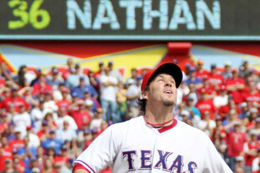 Texas closer Joe nathan watches the flight of the game ending fly ball in Texas' 3-2 win...