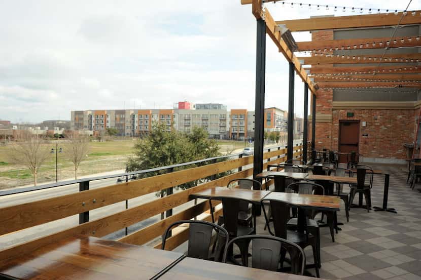 The large patio extended from Vetted Well features views of downtown Dallas at Alamo...
