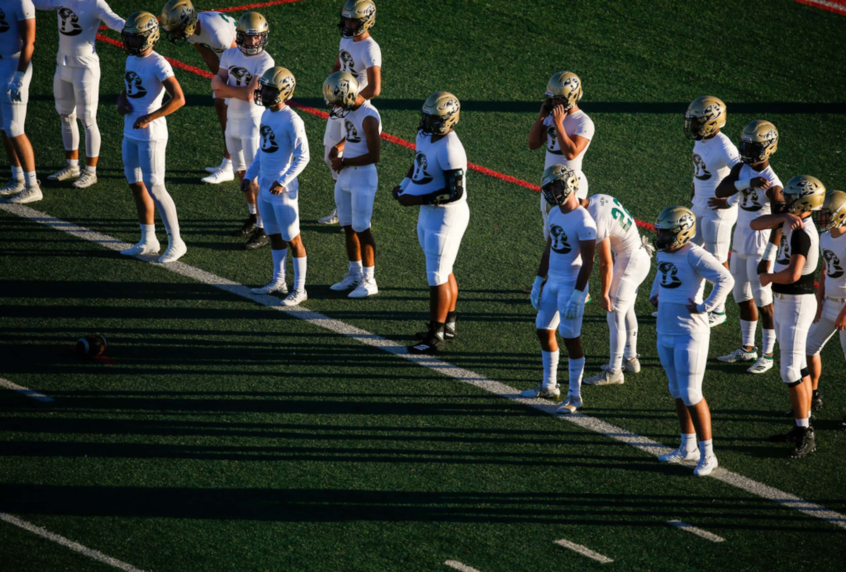 Birdville players warm up prior to a high school football game between Colleyville Heritage...
