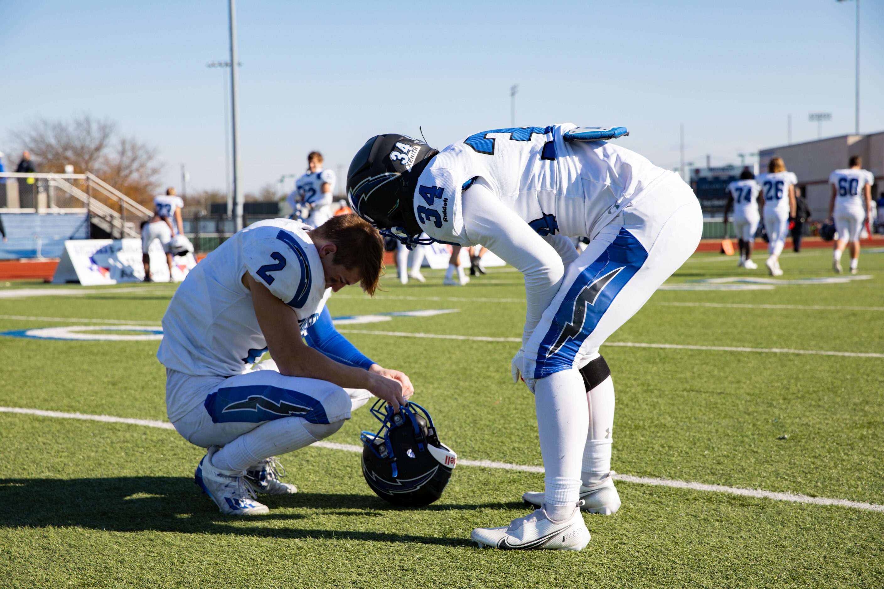 Dallas Christian player Jonathan Lang (34) comforts teammate Gabriel Grubbs (2) after losing...