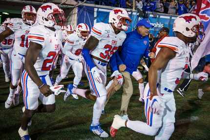 FILE - SMU head coach Sonny Dykes takes the field with his team before a game against...