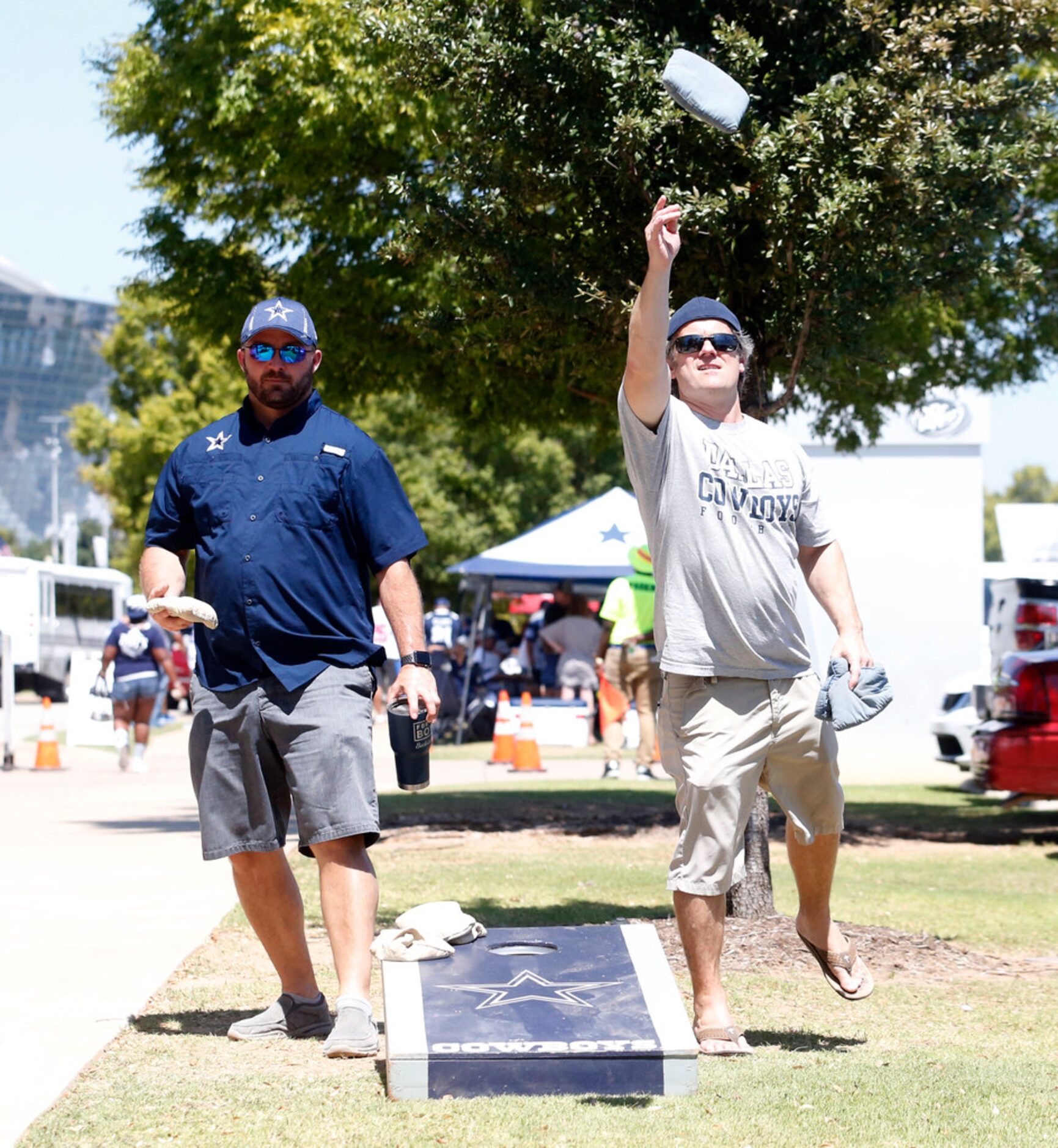 Jesse Roberts (left) of Houston and Charles Booth of Euless  play a game of corn hole before...