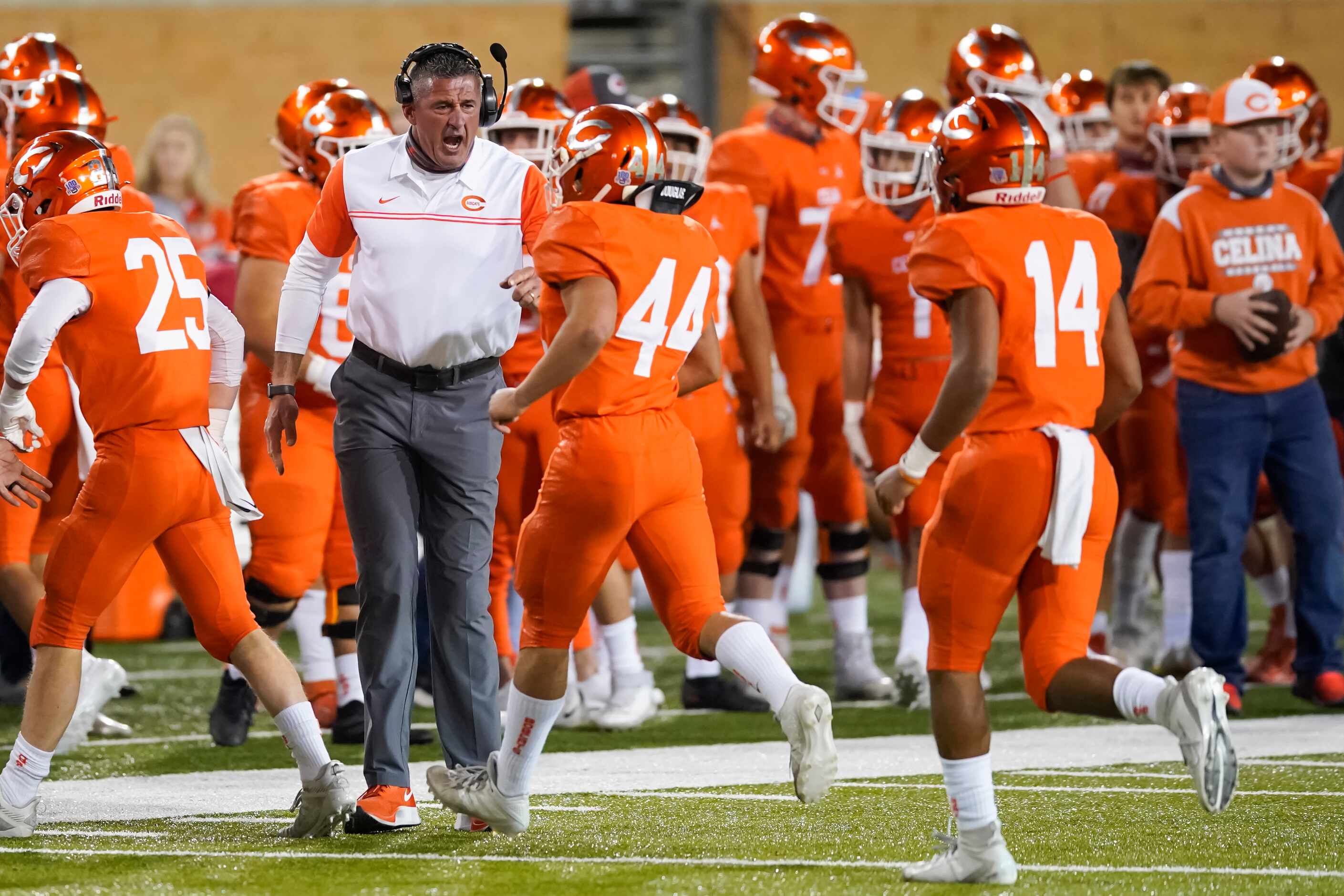 Celina head coach Bill Elliott celebrates after a Bobcats touchdown  during the first...