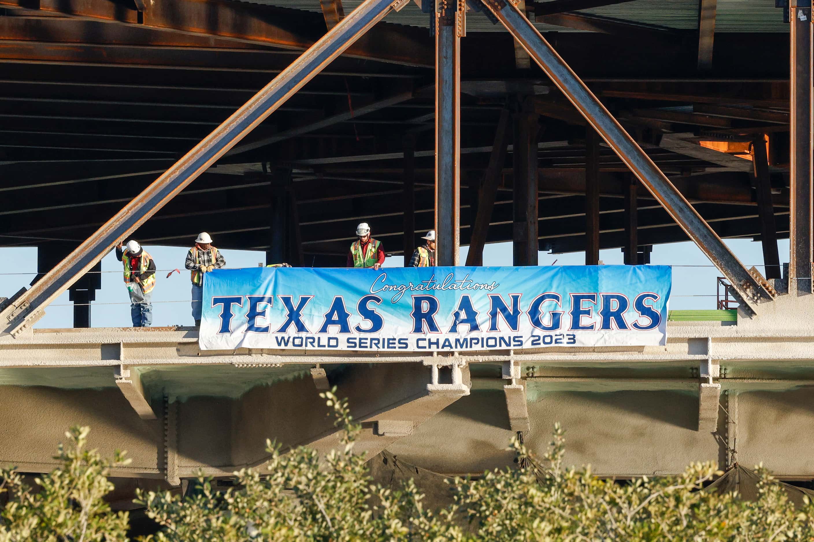 Construction workers at the Medal of Honor museum unveil a banner congratulating the Texas...