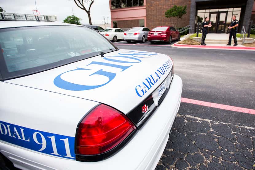 A Garland police car is parked outside the Garland ISD administration building in this file...
