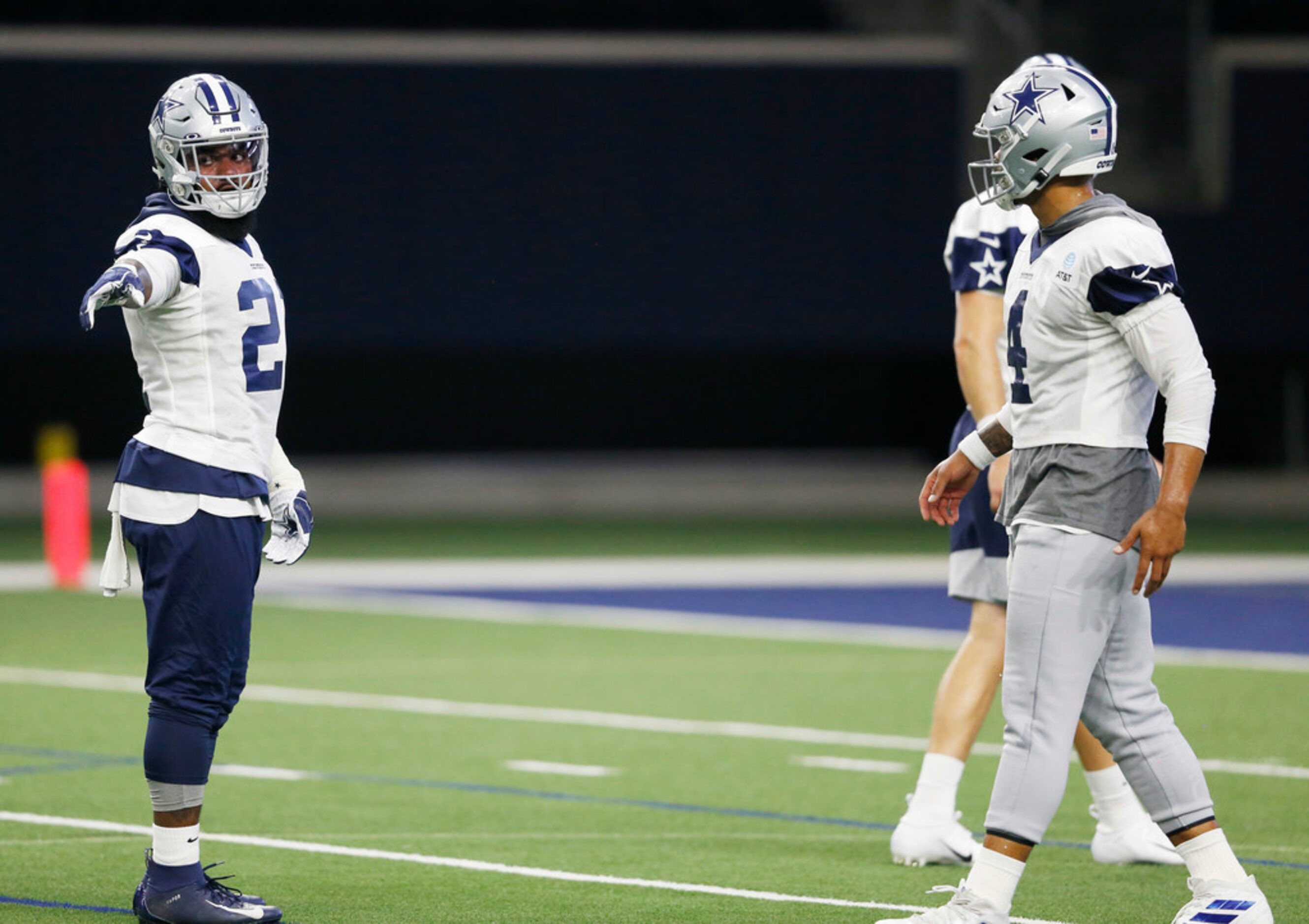 Dallas Cowboys running back Ezekiel Elliott (21) and Dallas Cowboys quarterback Dak Prescott...