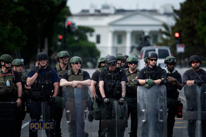 Members of the Federal Bureau of Prisons and other law enforcement block 16th Street NW near...