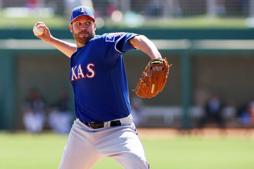 Mar 10, 2012; Glendale, AZ, USA; Texas Rangers starting pitcher Colby Lewis (48) pitches...
