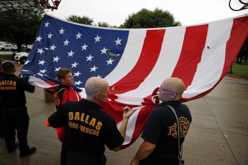 Plano fire Captain Chris Bechtold (right) and Dallas fire Captain Mike Bueller (second from...