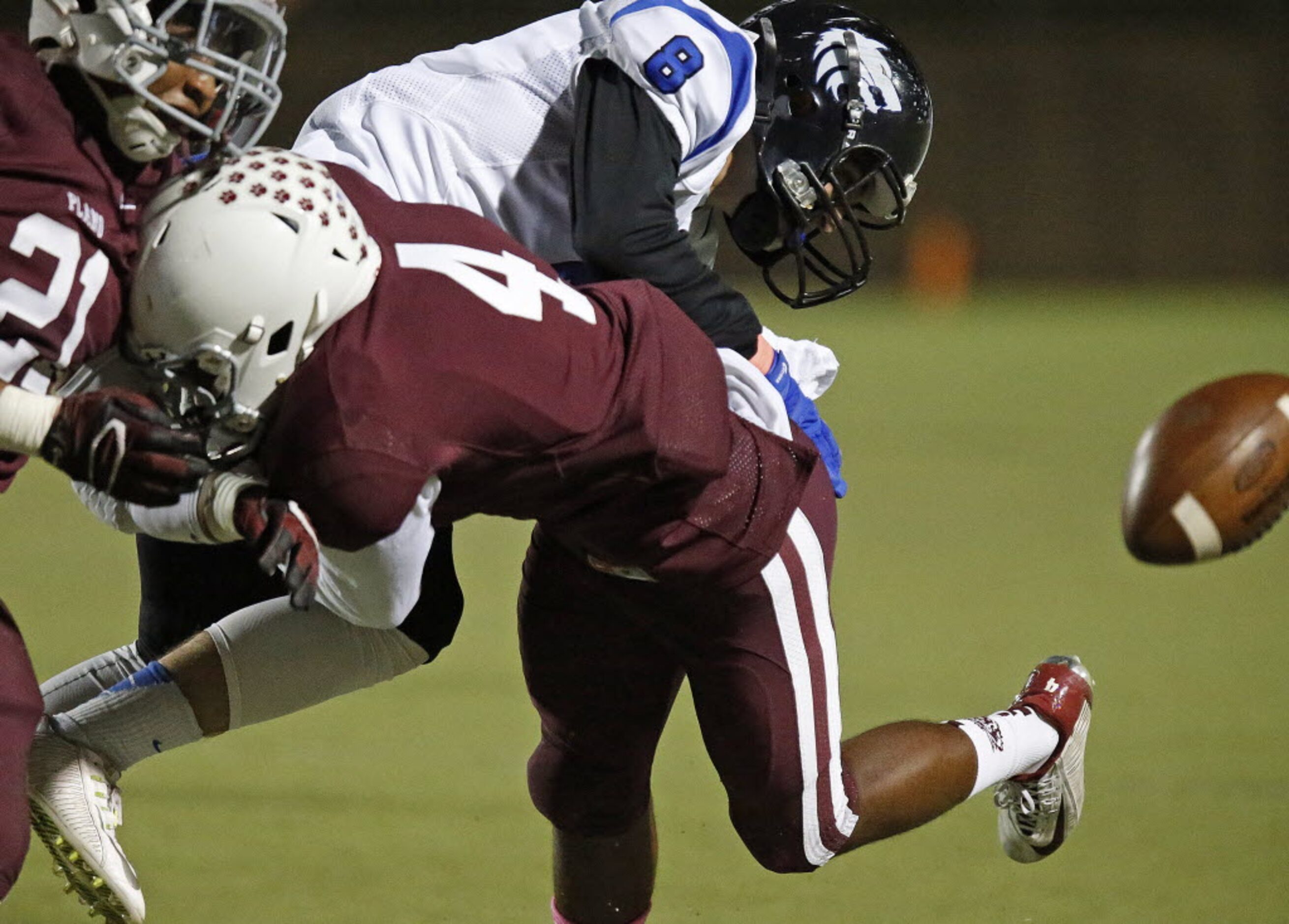 Plano High School defensive back C.J. Wall (4) puts a hit on Plano West High School wide...