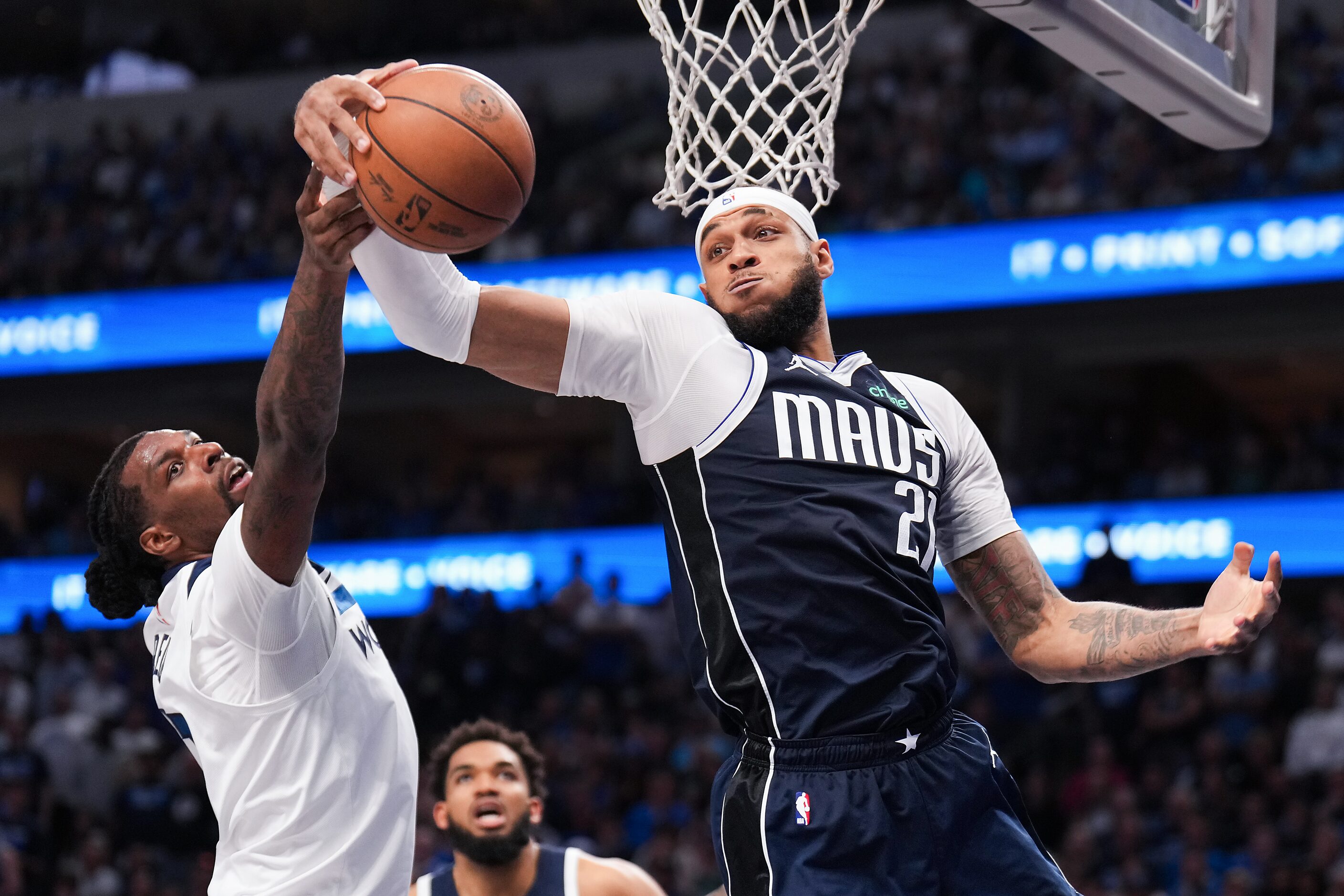 Dallas Mavericks center Daniel Gafford (21) grabs a rebound away from Minnesota Timberwolves...