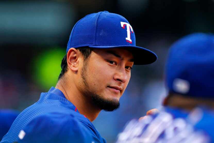 Texas Rangers starting pitcher Yu Darvish watch his teammates face the Miami Marlins at...