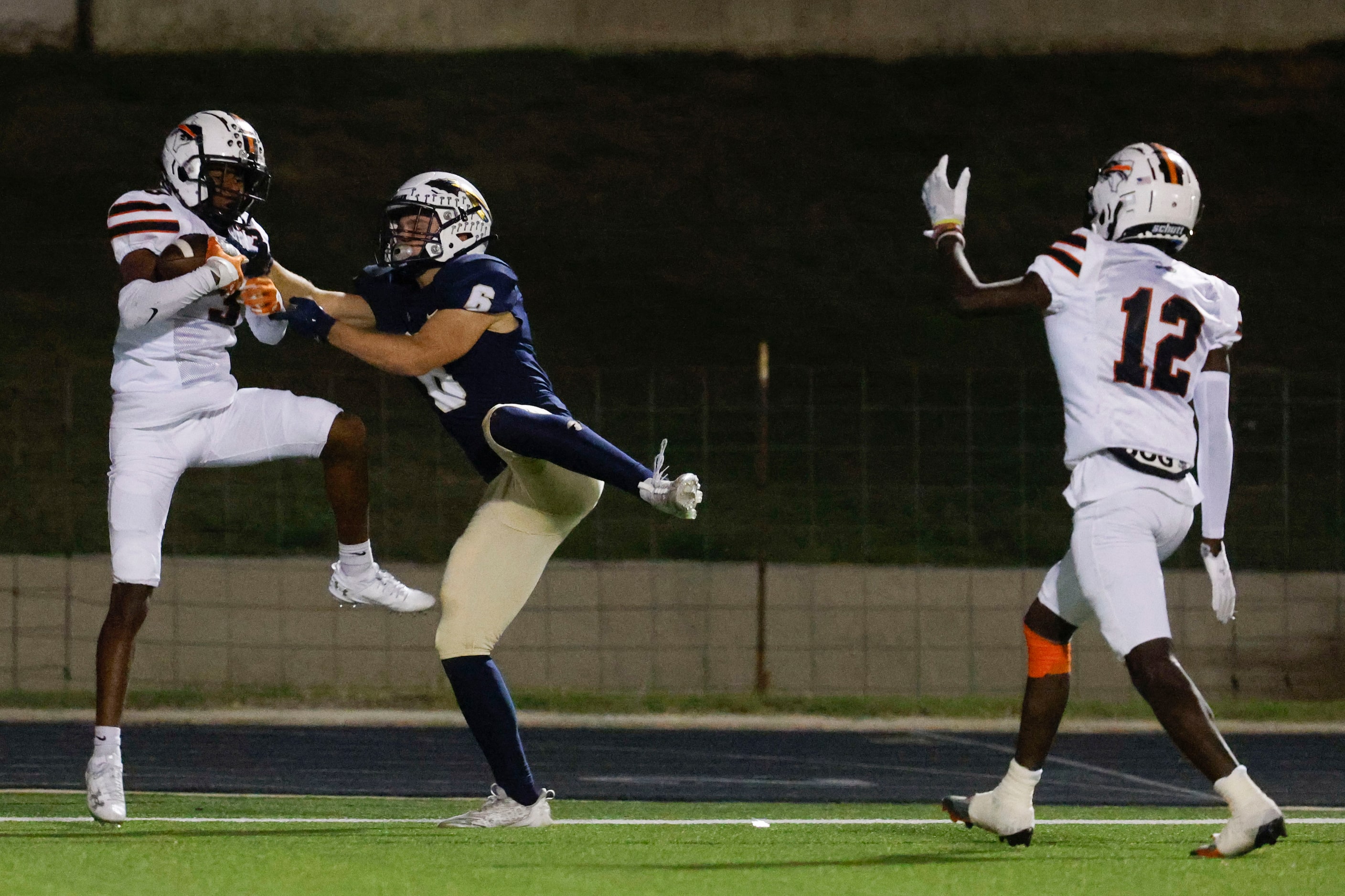 Haltom high’s Darius Harkless (left) intercepts a touchdown pass intended for Keller High’s...