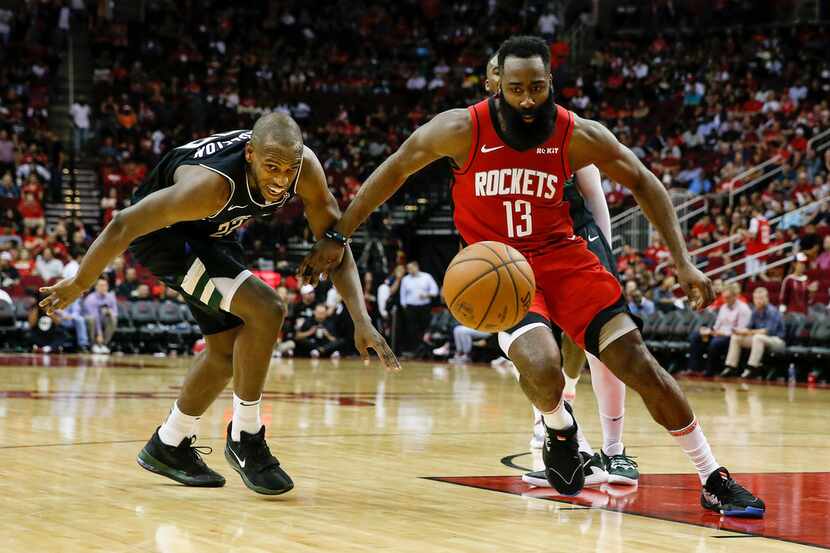 HOUSTON, TX - OCTOBER 24:  James Harden #13 of the Houston Rockets battles with Khris...